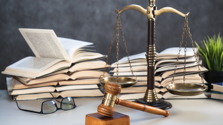 A close-up of a wooden gavel resting on a law book in a courtroom, symbolizing justice and legal authority