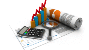 Financial charts, calculator, and magnifying glass representing analysis of profitable business ideas