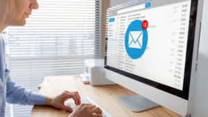 A professional working on a computer with an inbox open, illustrating SaaS email marketing campaigns and digital communication strategies.