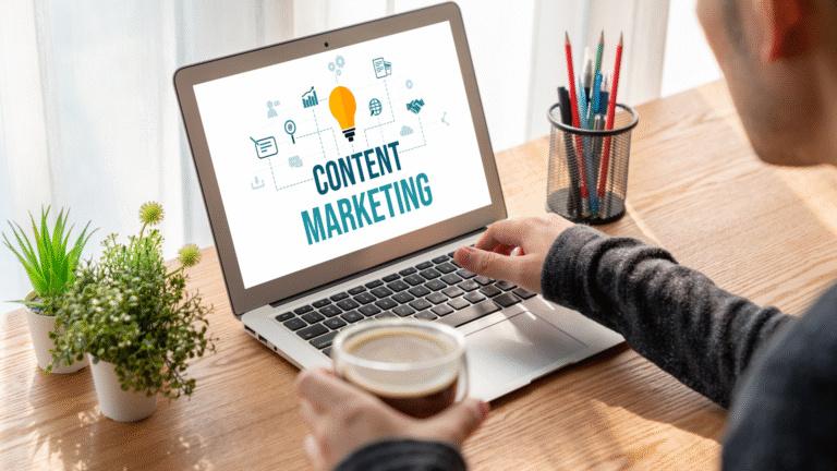 Person working on a laptop with the words "Content Marketing" displayed on the screen, representing digital strategy and business growth.