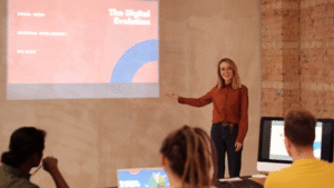 Educator presenting AI trends in education to a group of students with a projected slide showing topics like artificial intelligence and big data.