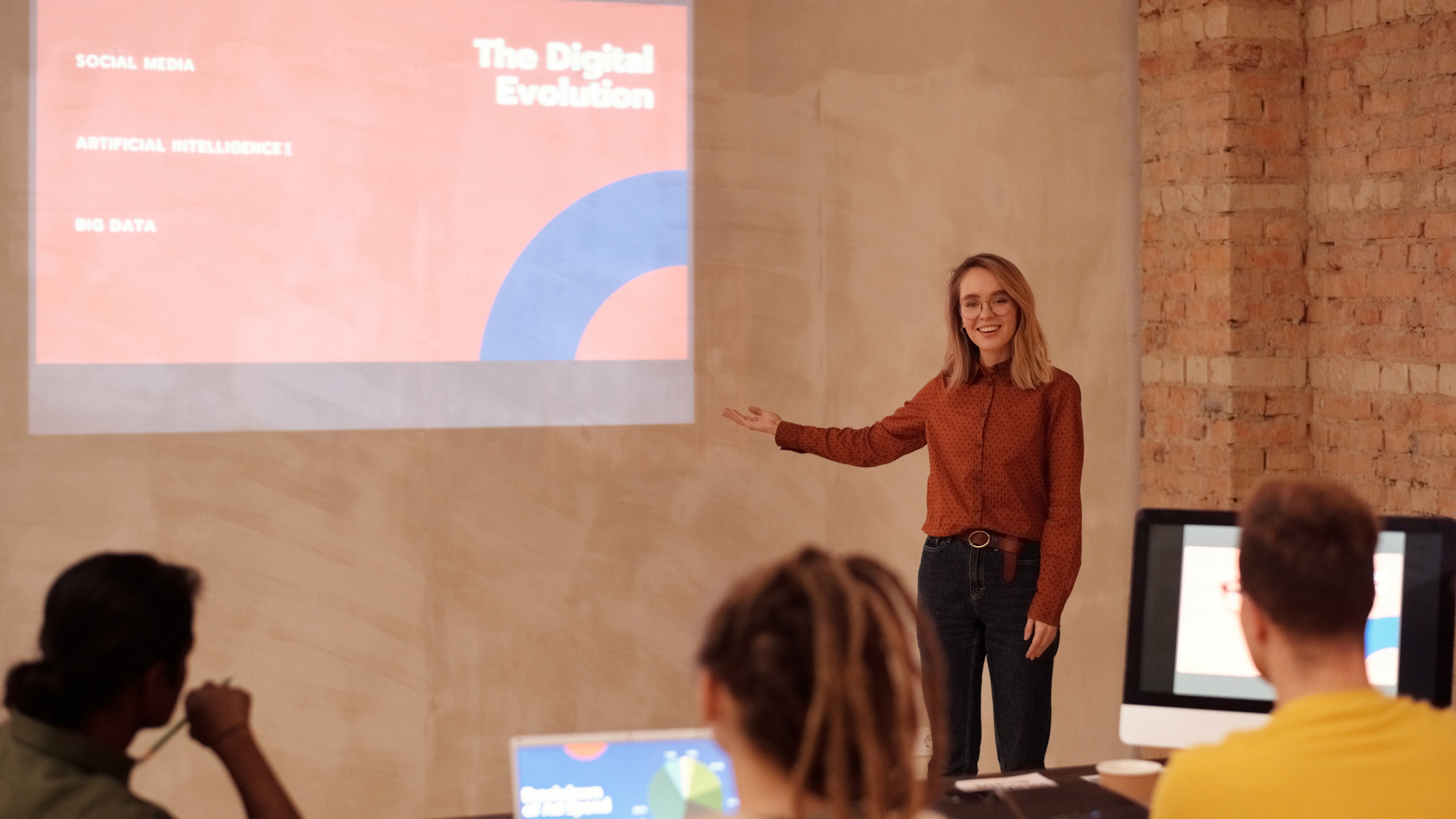 Educator presenting AI trends in education to a group of students with a projected slide showing topics like artificial intelligence and big data.