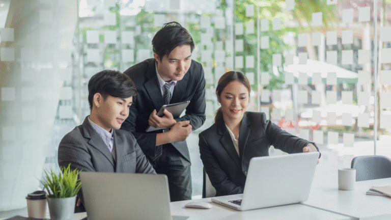 Team of professionals discussing business niches strategy on laptop in modern office setting