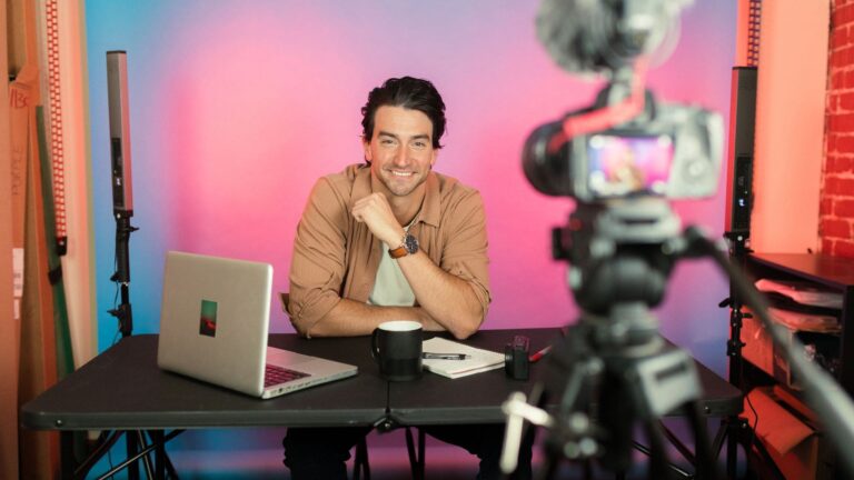 Content creator using laptop and camera setup, exploring AI tools in 2025 for productivity and creativity