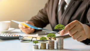 Businessman reviewing financial documents with stacked coins growing trees, symbolizing growth through investment options.