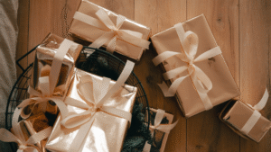 Beautifully wrapped presents with ribbons on a wooden floor, showcasing creative gift ideas.