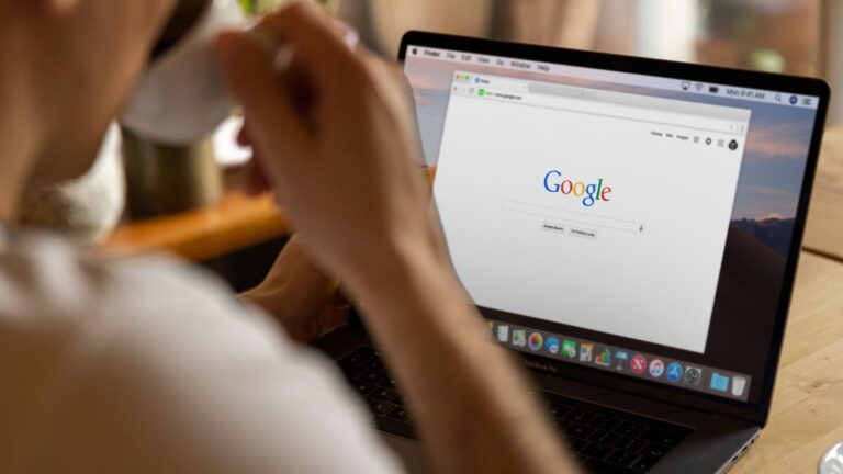 Person using Google search on a laptop to explore chrome extension tools for productivity