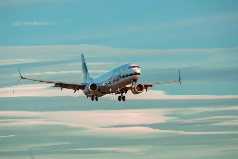 Airplane in the sky during sunset, symbolizing cheap flights and affordable travel options.
