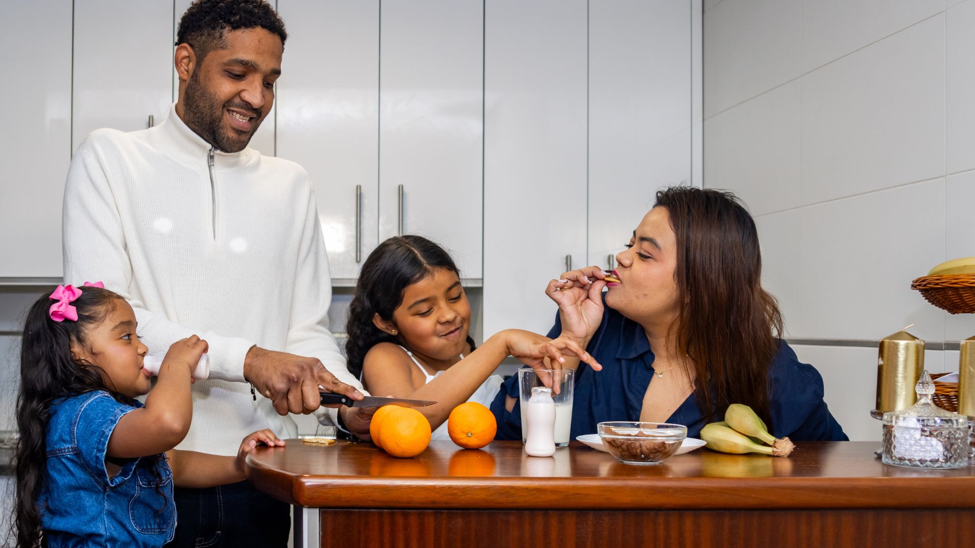 A happy family preparing breakfast together in a bright kitchen, showcasing small daily routines and micro-habits that transform your life through bonding, healthy eating, and mindful moments.