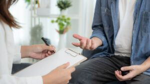 A person speaking with a mental health professional during a counseling session, illustrating the role of Mental Wellness Technology in supporting emotional well-being.
