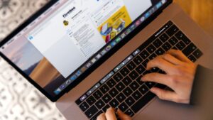 A person typing on a laptop while browsing the web, showing multiple tabs open for productivity and chrome extensions research.