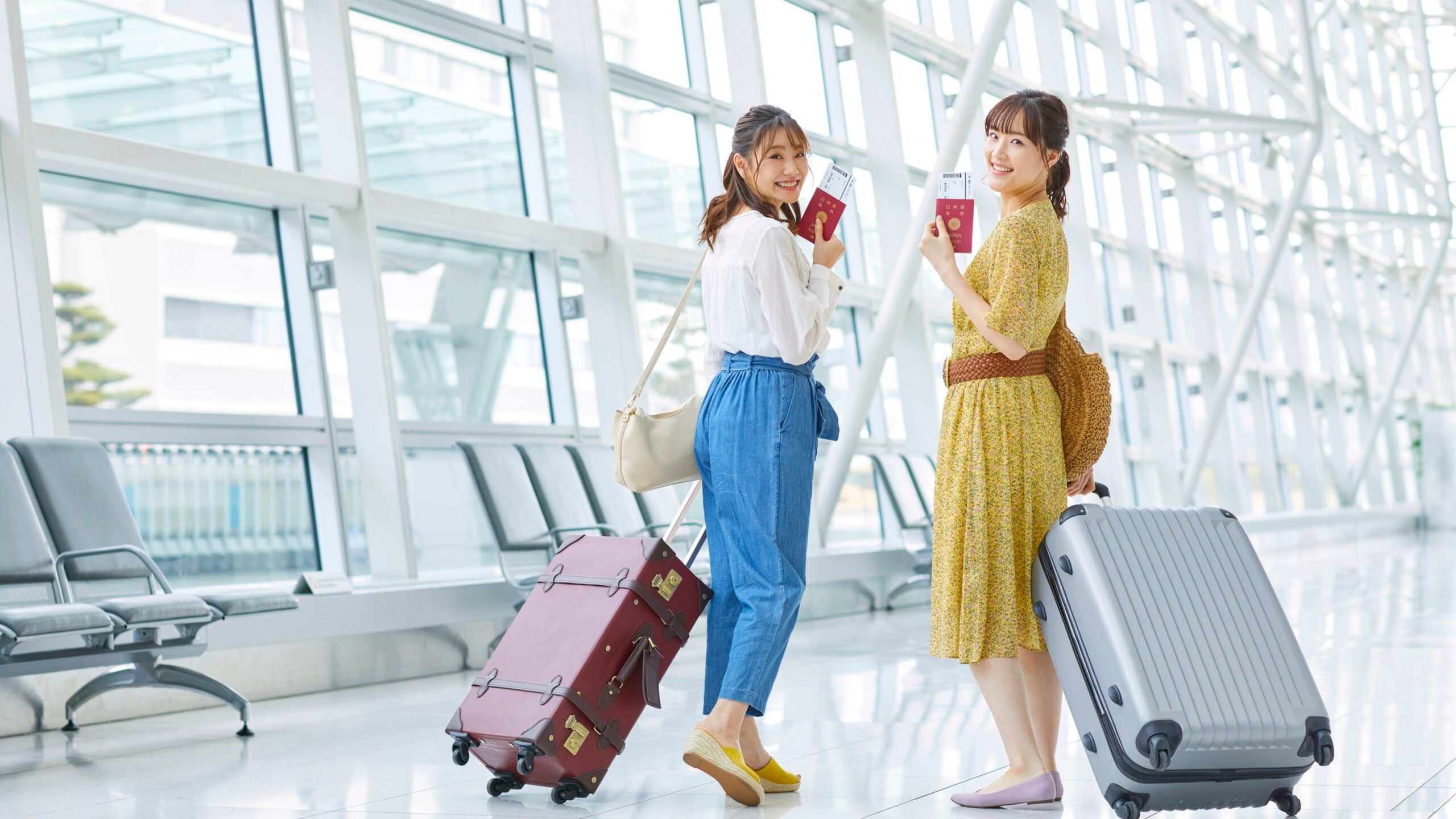 First-time international travelers at an airport holding passports and rolling suitcases, highlighting common travel mistakes first-time international travelers make, such as poor planning and overpacking.