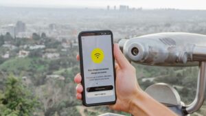 Smartphone showing an eSIM app interface overlooking a city viewpoint, illustrating the best eSIM apps for international travel in 2026 tested across multiple countries.