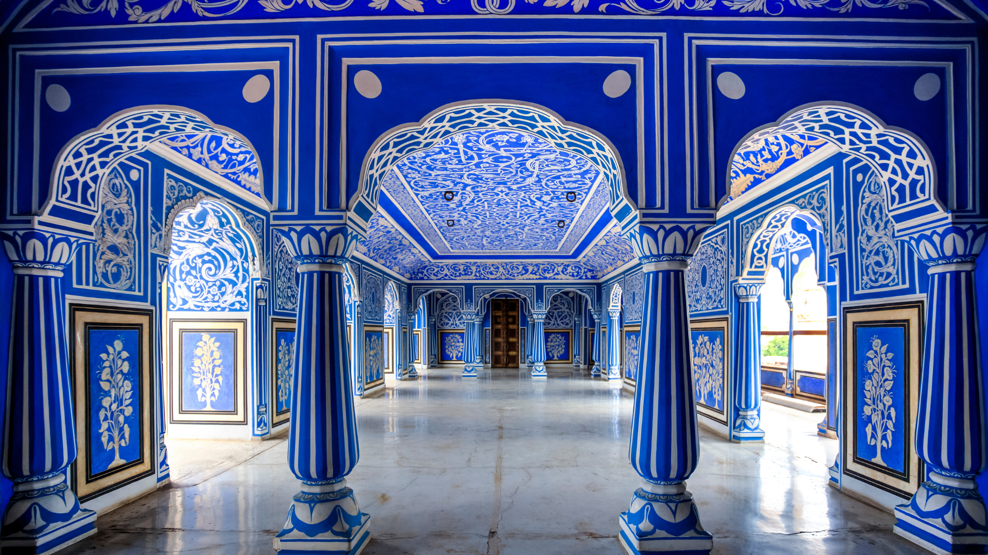 Intricate blue-painted palace interior showcasing royal architecture, one of the hidden places in India.