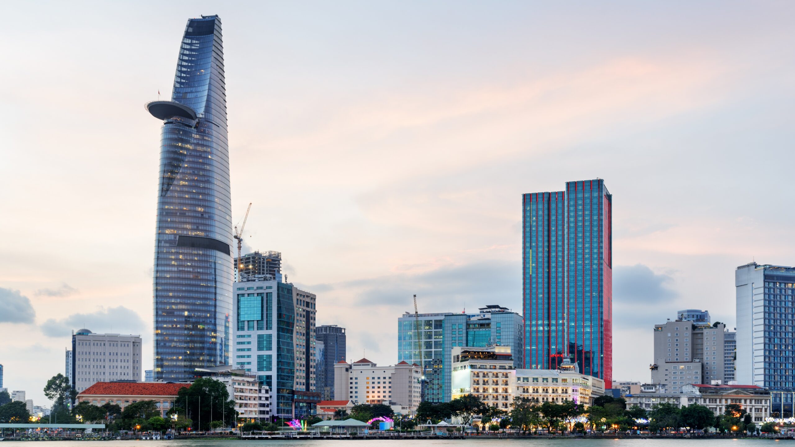Modern city skyline in Asia with high-rise buildings and riverfront at sunset