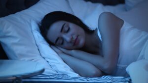 Why good sleep fixes more than you think shown through a woman sleeping peacefully at night