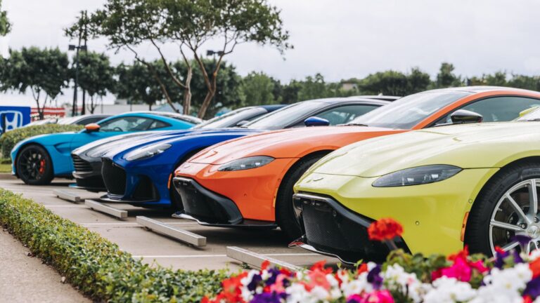 Lineup of colorful vehicles parked in a row, showcasing options similar to affordable cars for buyers in 2026.