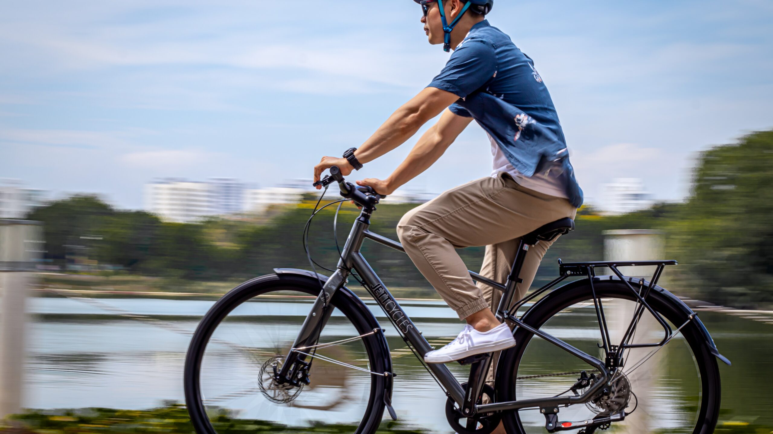 Man riding a bicycle during a scenic bike trip along a lakeside path