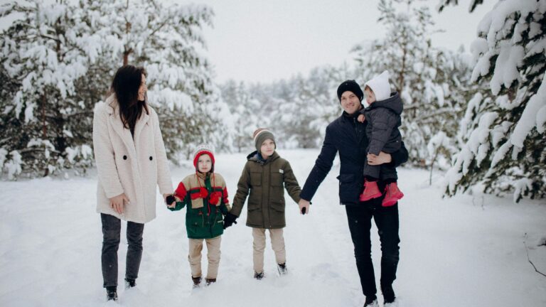 Family enjoying a snowy outdoor walk together during a Christmas Vacation