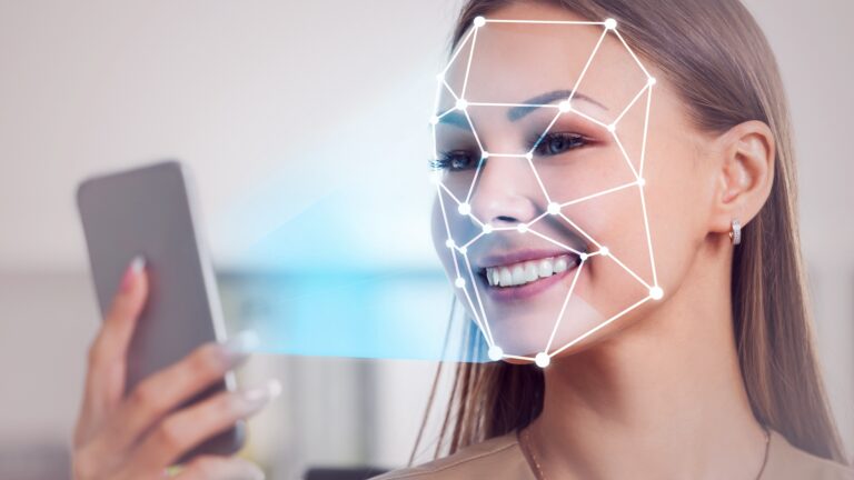 Smartphone-based Facial Recognition system analyzing facial features with biometric data points displayed.