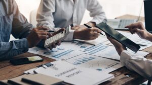 Funding Options for Startups: Venture Capital vs. Crowdfunding illustrated by a team reviewing financial reports, charts, and investment data during a business meeting.