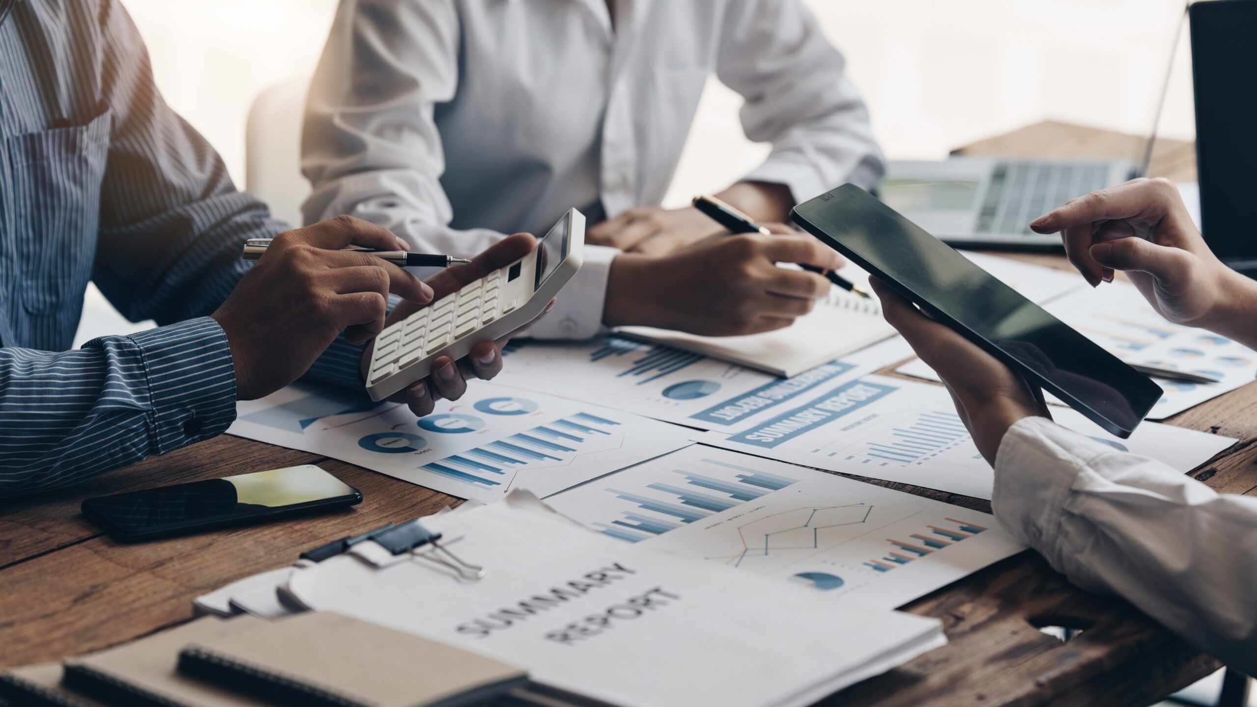 Funding Options for Startups: Venture Capital vs. Crowdfunding illustrated by a team reviewing financial reports, charts, and investment data during a business meeting.