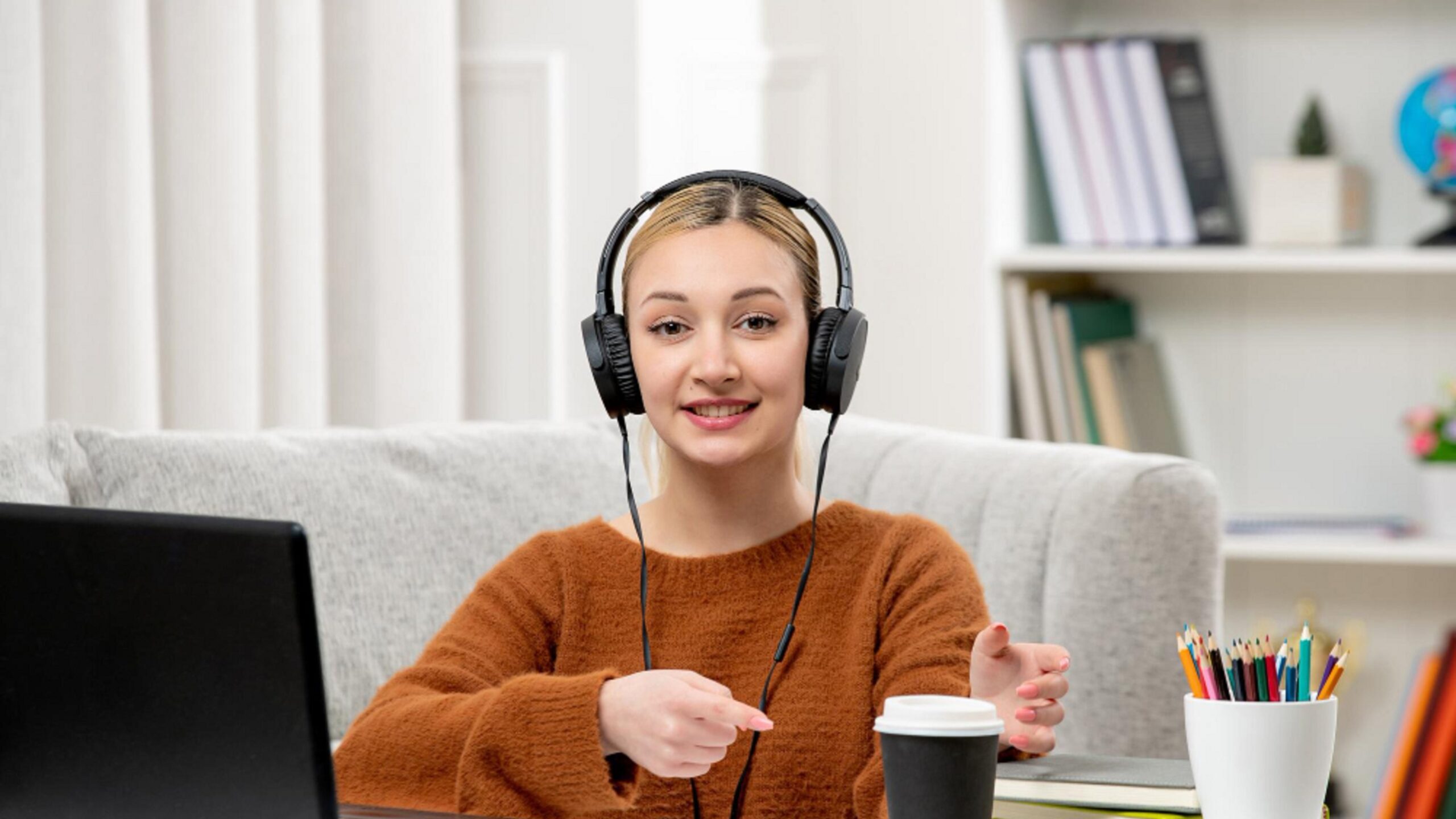 Apps That Help You Practice Math Without Feeling Bored shown through a student using headphones and a laptop while learning math in a comfortable home study setup.