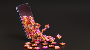 Instagram Reels Strategy for Small Local Businesses illustrated by a smartphone displaying exploding social media icons, symbolizing content reach and engagement growth.