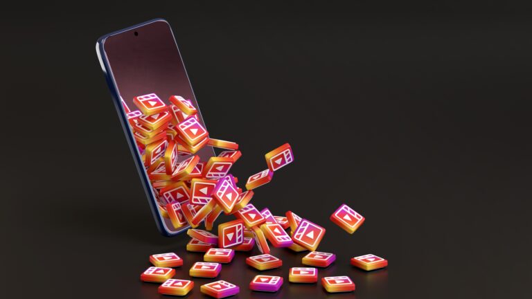 Instagram Reels Strategy for Small Local Businesses illustrated by a smartphone displaying exploding social media icons, symbolizing content reach and engagement growth.