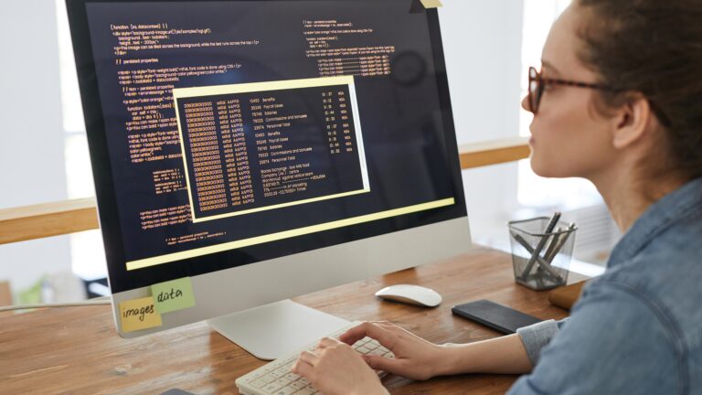 Beginner developer working on free coding projects for beginners to build your portfolio on a desktop computer.