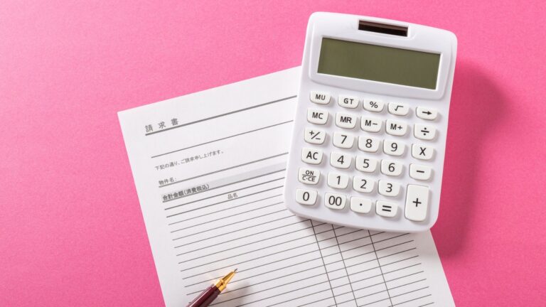 Affordable Tools for Managing Invoices and Expenses in Startups shown with a calculator placed on an invoice sheet and a pen on a pink background, representing startup accounting and expense tracking