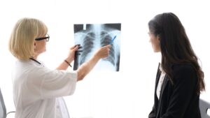 Doctor explaining a chest X-ray to a female patient during consultation, highlighting preventive care and Building Better Bone Health: Simple Nutrition and Movement Tips for Women.